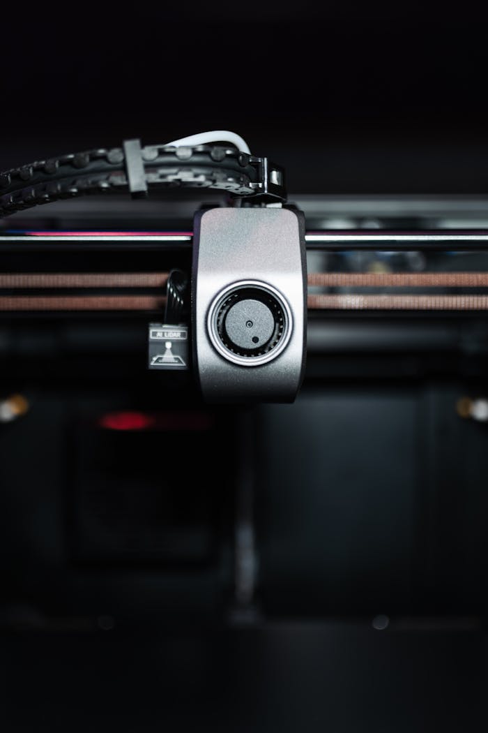 Detailed view of a 3D printer component in operation, showcasing technology and precision.
